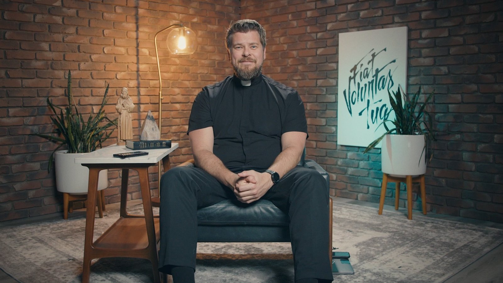 man sitting in chair father michael nixon in video production studio